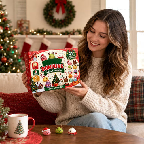 Woman holding the Christmas Dumpling Advent Calendar by the tree